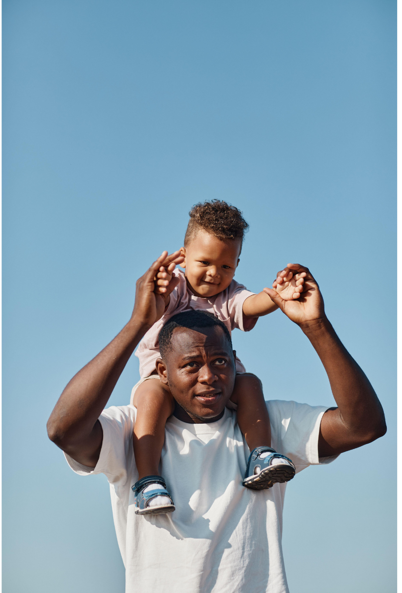 paternity young son on father's shoulders